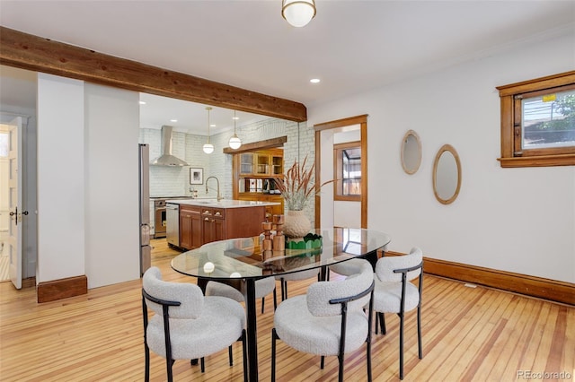 dining space with light wood-type flooring, beamed ceiling, baseboards, and recessed lighting