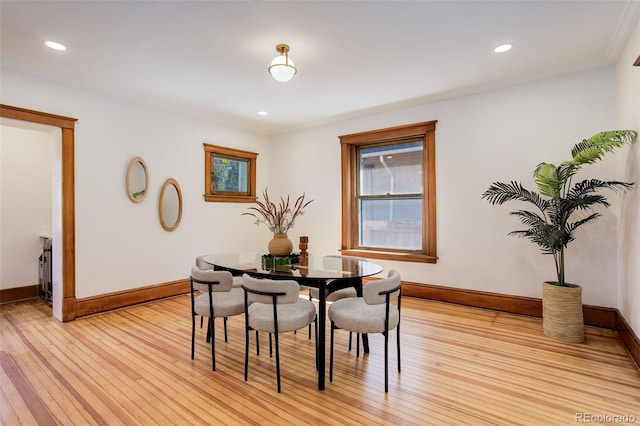 dining room featuring baseboards, light wood-style flooring, recessed lighting, and crown molding