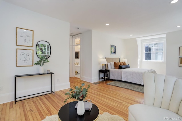 bedroom with wood finished floors, recessed lighting, multiple windows, and baseboards