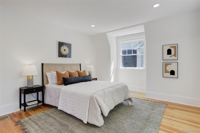 bedroom featuring baseboards, recessed lighting, and wood finished floors