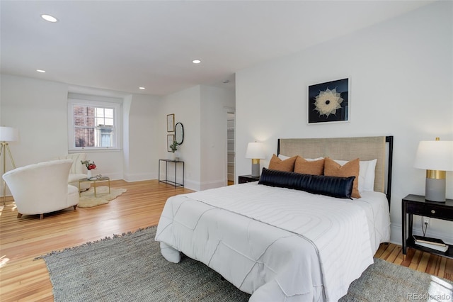 bedroom featuring wood finished floors, recessed lighting, and baseboards