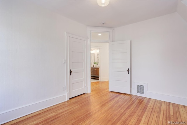 empty room with light wood finished floors