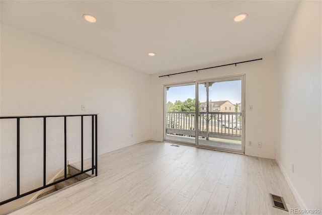 spare room featuring light hardwood / wood-style flooring