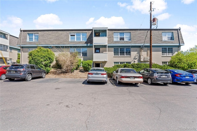 view of building exterior featuring uncovered parking