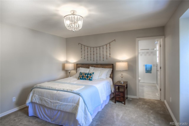 carpeted bedroom with a chandelier, ensuite bath, and baseboards