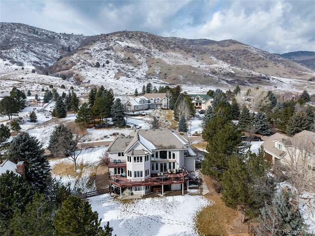 snowy aerial view featuring a residential view and a mountain view