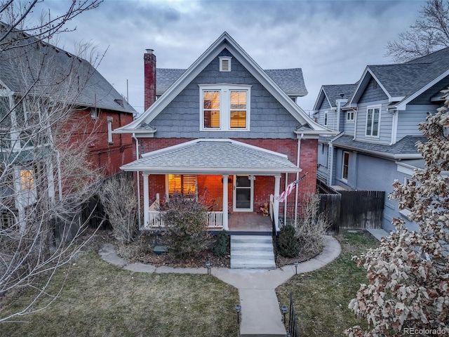 view of front of home featuring a front yard and covered porch