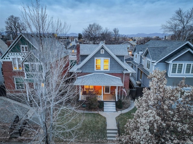 view of front facade featuring a mountain view and covered porch