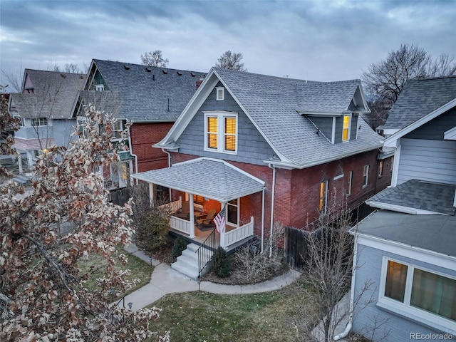 rear view of property with a porch