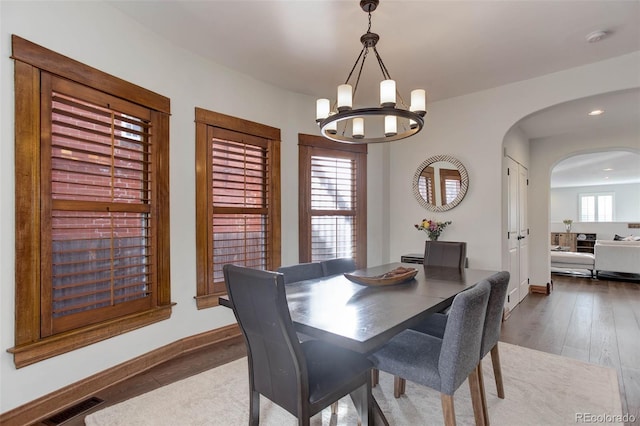 dining space featuring hardwood / wood-style flooring, a chandelier, and a wealth of natural light