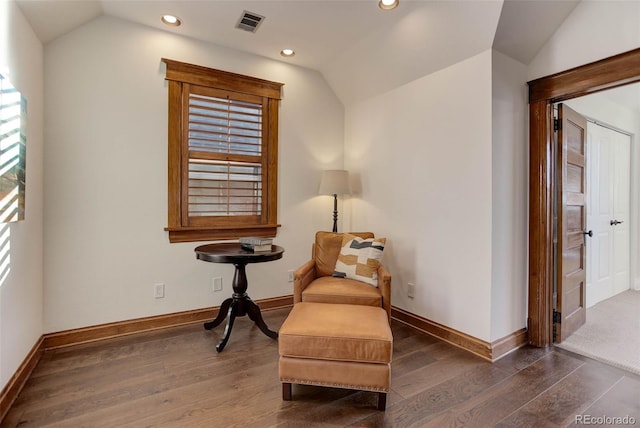 living area featuring dark hardwood / wood-style flooring and vaulted ceiling