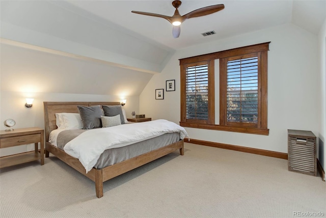 bedroom featuring ceiling fan, lofted ceiling, and light carpet