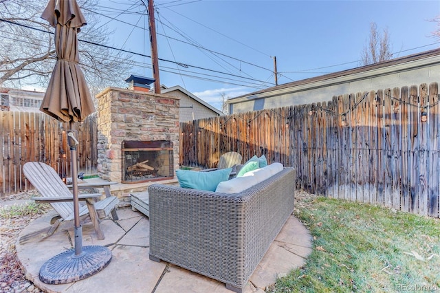 view of patio with an outdoor stone fireplace