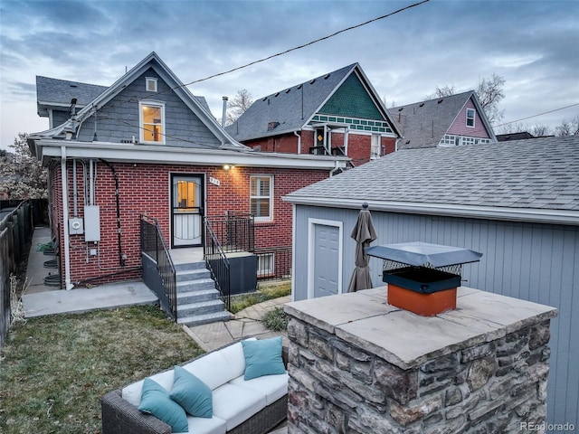 rear view of house featuring an outdoor hangout area