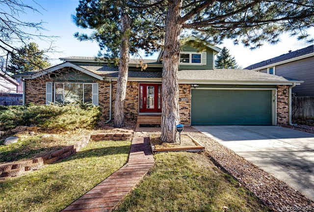 view of front of home with a front lawn and a garage