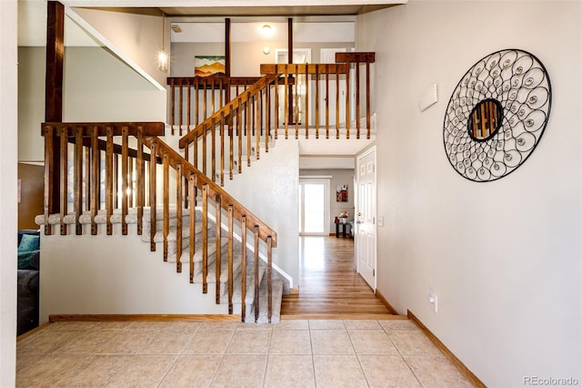 stairway featuring tile patterned flooring