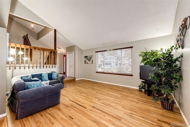 living room with hardwood / wood-style floors and vaulted ceiling