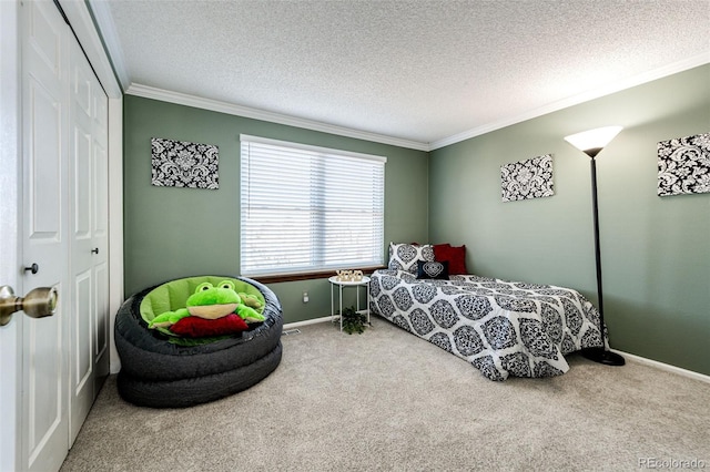 carpeted bedroom featuring a closet, a textured ceiling, and ornamental molding