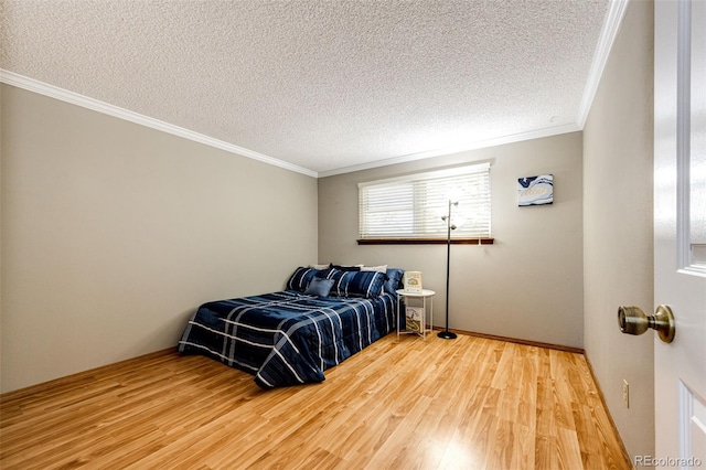 bedroom with crown molding, a textured ceiling, and hardwood / wood-style flooring