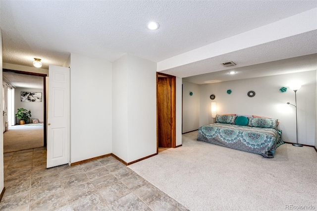 carpeted bedroom with a textured ceiling