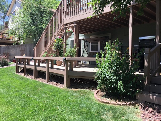 wooden terrace featuring a lawn