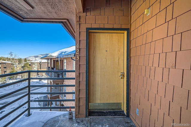 doorway to property with a mountain view and a balcony