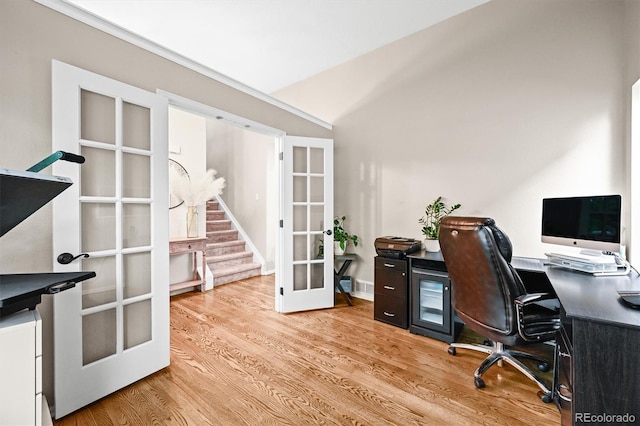 office area featuring french doors, wood finished floors, and lofted ceiling