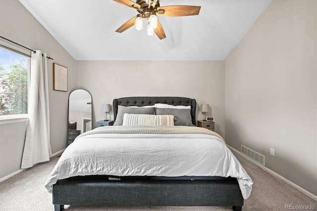 carpeted bedroom with lofted ceiling, ceiling fan, and baseboards