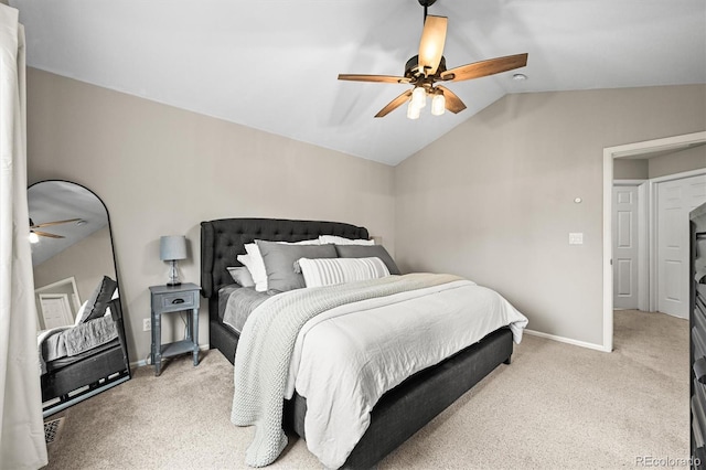 carpeted bedroom featuring vaulted ceiling, baseboards, and a ceiling fan