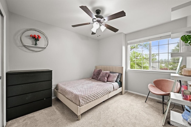 carpeted bedroom with baseboards and ceiling fan