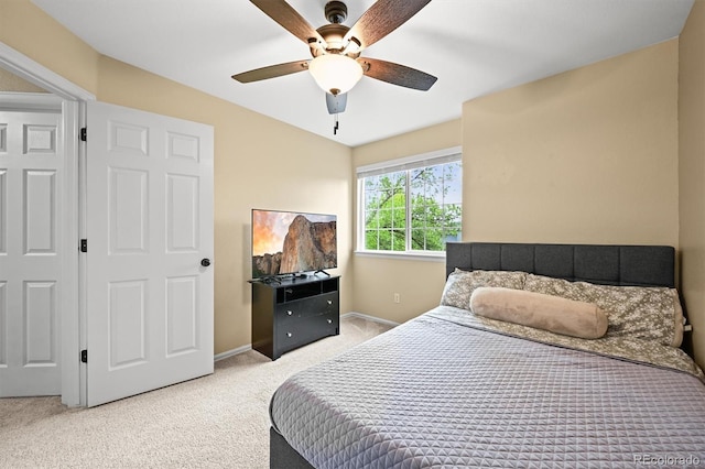 carpeted bedroom featuring baseboards and ceiling fan