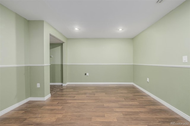 unfurnished room with wood-type flooring