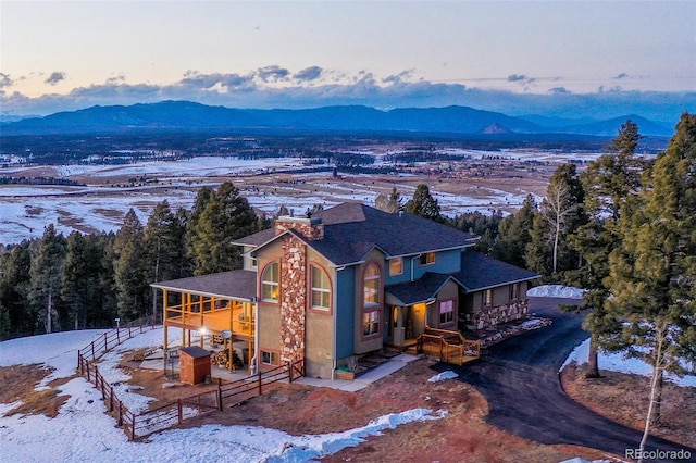 snowy aerial view with a mountain view