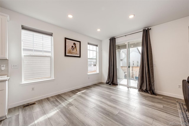 unfurnished room with light hardwood / wood-style floors