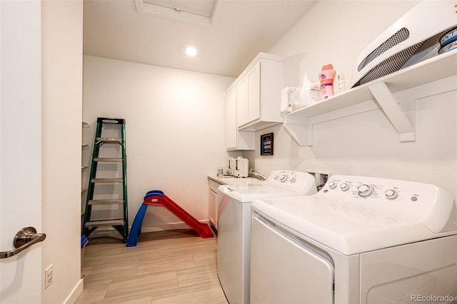 clothes washing area with cabinets and independent washer and dryer