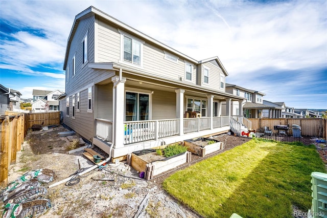 rear view of house featuring a yard