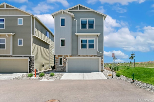 7407 Rufous Fronted Vw, Colorado Springs, CO 80923 - view of front of home with a garage, stone siding, and driveway