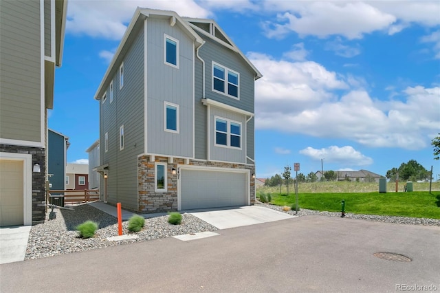 7407 Rufous Fronted Vw, Colorado Springs, CO 80923 - view of front facade featuring stone siding, driveway, and an attached garage