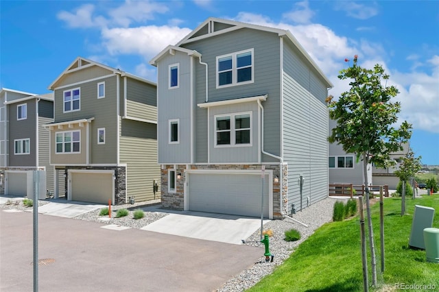 7407 Rufous Fronted Vw, Colorado Springs, CO 80923 - view of front facade with a garage, driveway, stone siding, and a front yard