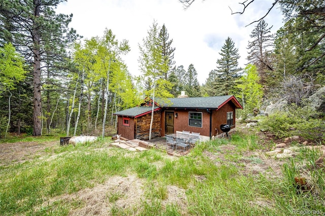 12346 Bear Haven Rd, Conifer, CO 80433 - back of property with a forest view and a chimney