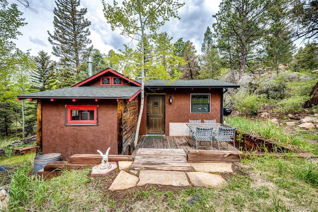 12346 Bear Haven Rd, Conifer, CO 80433 - view of front of home with stucco siding and a wooden deck