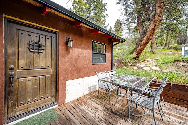 12346 Bear Haven Rd, Conifer, CO 80433 - wooden deck featuring outdoor dining area
