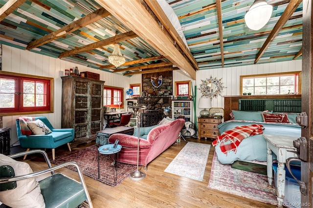 12346 Bear Haven Rd, Conifer, CO 80433 - living room with wood finished floors, beam ceiling, and wooden walls