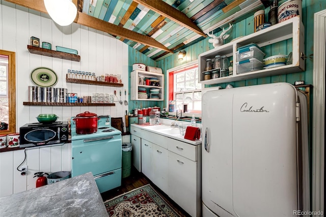 12346 Bear Haven Rd, Conifer, CO 80433 - kitchen featuring open shelves, refrigerator, dark wood-style floors, wood walls, and black microwave