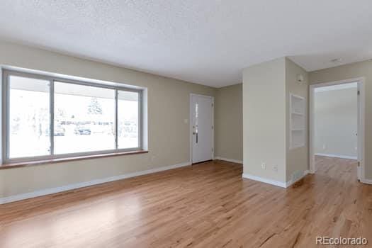 unfurnished room featuring light hardwood / wood-style floors