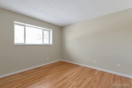 empty room featuring light hardwood / wood-style flooring and a textured ceiling