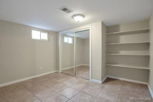 unfurnished bedroom featuring light tile patterned floors and a closet