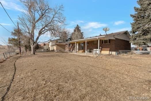 rear view of property featuring a patio