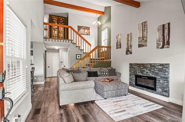 943 S Fairplay St, Aurora, CO 80012 - living room with beamed ceiling, stairway, dark wood-style floors, a chandelier, and baseboards