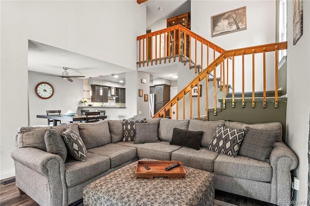 943 S Fairplay St, Aurora, CO 80012 - living area with ceiling fan, wood finished floors, stairway, and a towering ceiling